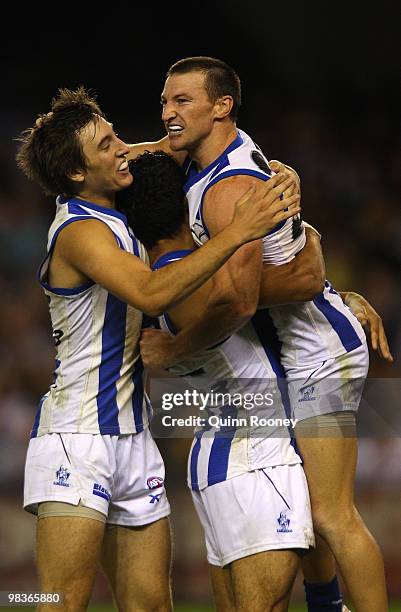 Brent Harvey of the Kangaroos is congratulated by team-mates after kicking a goal during the round three AFL match between the North Melbourne...