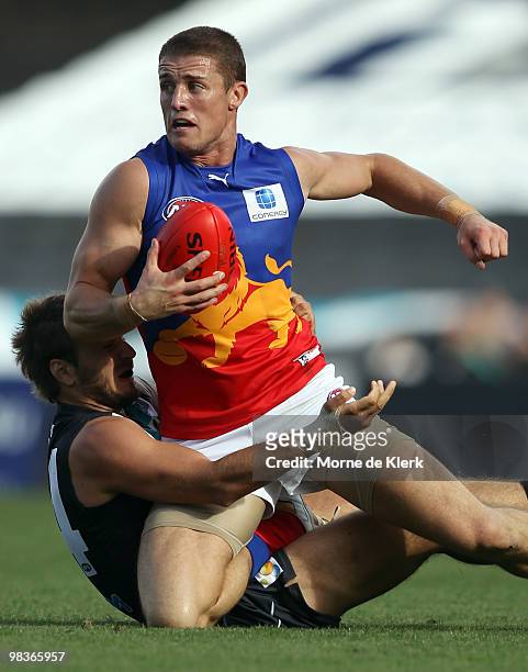 Matt Maguire of the Lions is tackled by Tom Logan of the Power during the round three AFL match between Port Adelaide Power and Brisbane Lions at...
