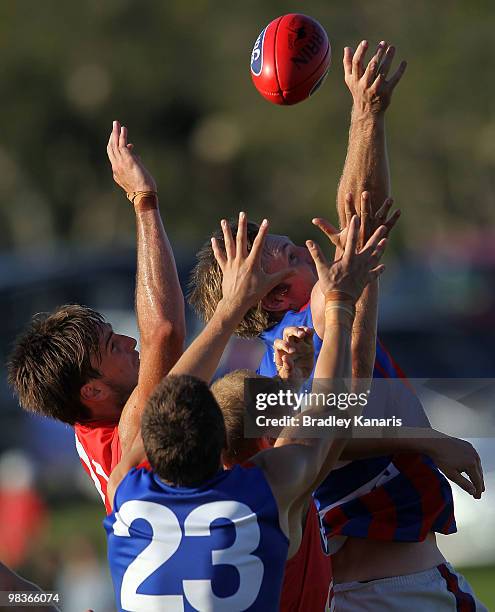 Nathan Ablett of the Gold Coast and Hugh Sandiland and Sam Pleming of Port Melbourne compete for the ball during the round one VFL match between the...