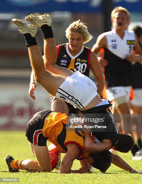 Callum Currie of the Rebels tackles Lachlan Wallace of the Stingrays during the round three TAC Cup match between the Dandenong Stingrays and the...