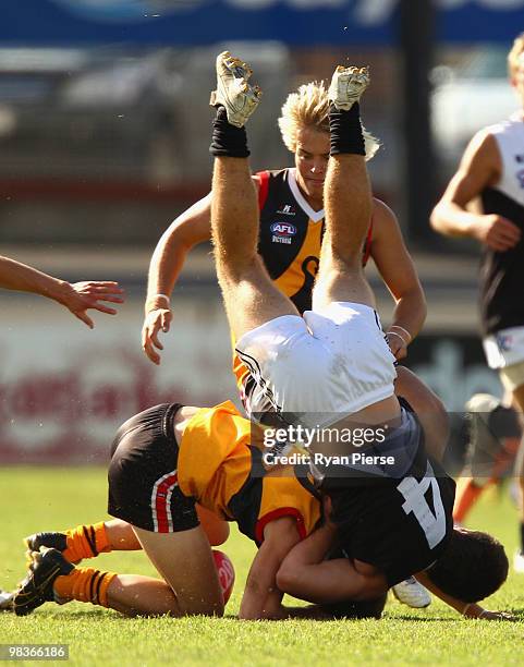 Callum Currie of the Rebels tackles Lachlan Wallace of the Stingrays during the round three TAC Cup match between the Dandenong Stingrays and the...