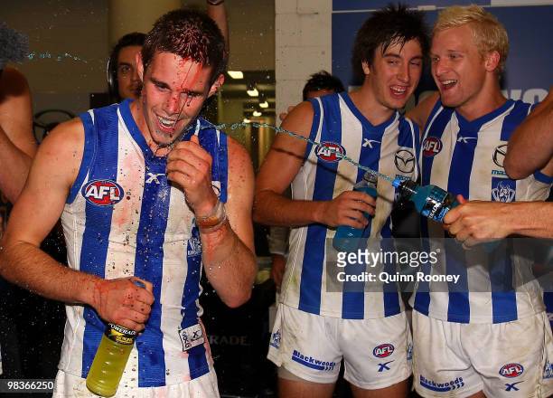 Ryan Bastinac of the Kangaroos is sprayed with drinks by team-mates after playing in his first winning game during the round three AFL match between...