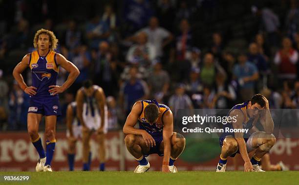 Matt Priddis, Brad Ebert and Luke Shuey of the Eagles look dejected after losing the round three AFL match between the North Melbourne Kangaroos and...