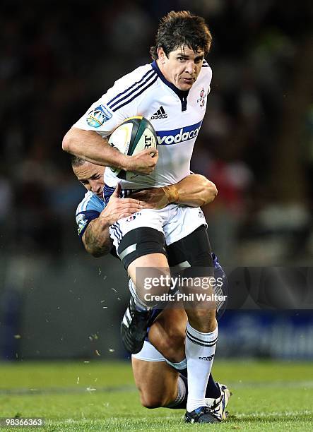 Jaque Fourie of the Stomers is tackled by Luke McAlister of the Blues during the round nine Super 14 match between the Blues and the Stormers at Eden...