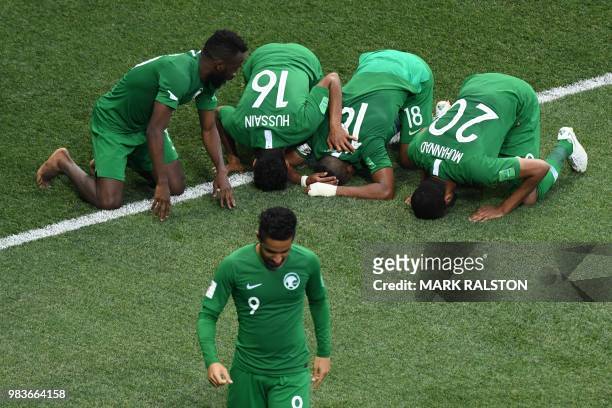 Saudi players celebrate their winning goal during the Russia 2018 World Cup Group A football match between Saudi Arabia and Egypt at the Volgograd...