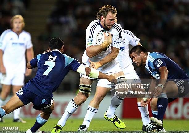 Andries Bekker of the Stormers is tackled by Serge Lilo of the Blues during the round nine Super 14 match between the Blues and the Stormers at Eden...