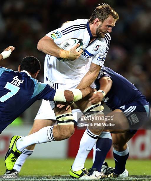 Andries Bekker of the Stormers is tackled by Serge Lilo of the Blues during the round nine Super 14 match between the Blues and the Stormers at Eden...