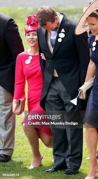 Autumn Phillips curtsies and Peter Phillips bows his head as Queen Elizabeth II passes by in her horse drawn carriage on day 5 of Royal Ascot at...