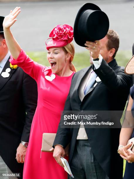 Autumn Phillips and Peter Phillips wave as Queen Elizabeth II's carriage procession passes by on day 5 of Royal Ascot at Ascot Racecourse on June 23,...