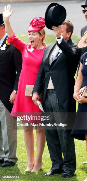 Autumn Phillips and Peter Phillips wave as Queen Elizabeth II's carriage procession passes by on day 5 of Royal Ascot at Ascot Racecourse on June 23,...