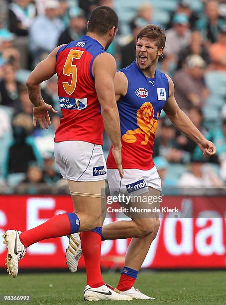 Justin Sherman and Brendan Fevola of the Lions celebrate a goal during the round three AFL match between Port Adelaide Power and Brisbane Lions at...