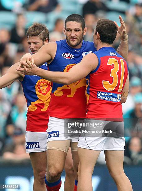 Brendan Fevola of the Lions is congratulated by team mates after kicking a goal during the round three AFL match between Port Adelaide Power and...