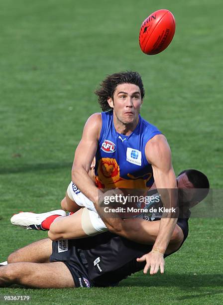 Troy Chaplin of the Power tackles Brent Staker of the Lions during the round three AFL match between Port Adelaide Power and Brisbane Lions at AAMI...