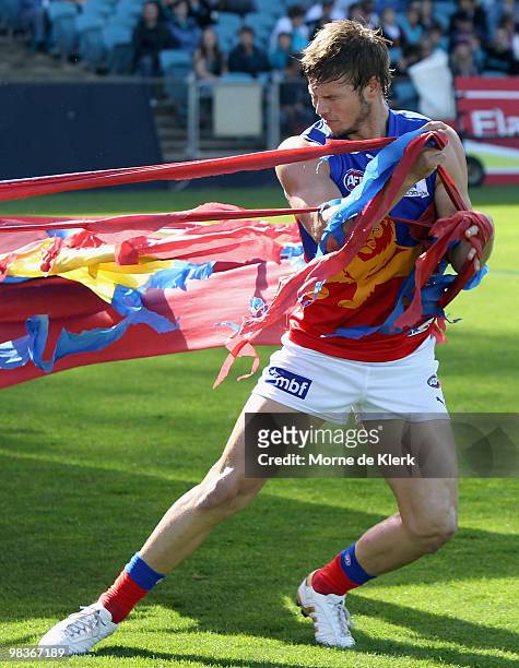Justin Sherman of the Lions has trouble getting through the banner before the round three AFL match between Port Adelaide Power and Brisbane Lions at...