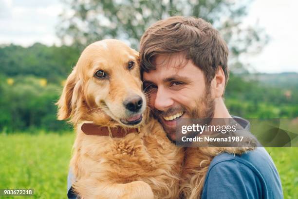 guy and his dog, golden retriever, nature - golden guys stock pictures, royalty-free photos & images