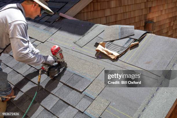 installing new roof with nail gun - roofer stock pictures, royalty-free photos & images