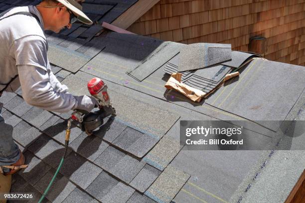 installing new roof with nail gun - telhado imagens e fotografias de stock