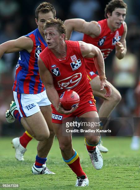 Daniel Harris of the Gold Coast looks to get a handball away during the round one VFL match between the Gold Coast Football Club and Port Melbourne...