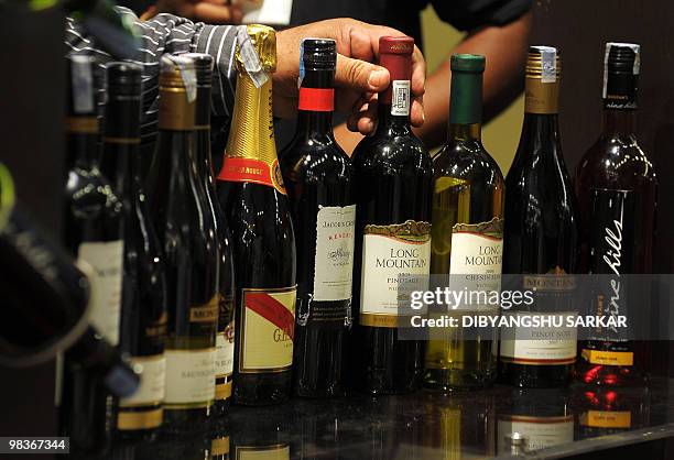 An Indian winery employee arranges a display of wines during the Bangalore International Wine Festival in Bangalore on April 10, 2010. The Karnataka...