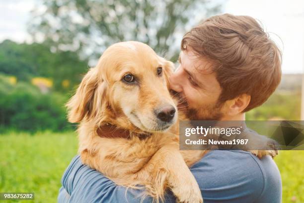 guy and his dog, golden retriever, nature - lab puppies stock pictures, royalty-free photos & images
