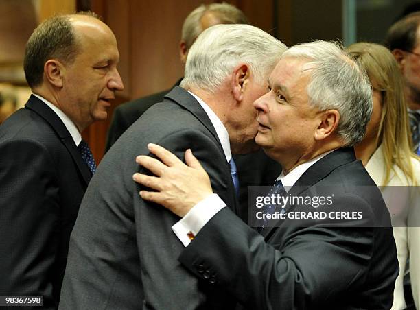 Polish President Lech Kaczynski hugs Lithuanian President Valdas Adamkus prior to a working session of an EU summit at the European Council...