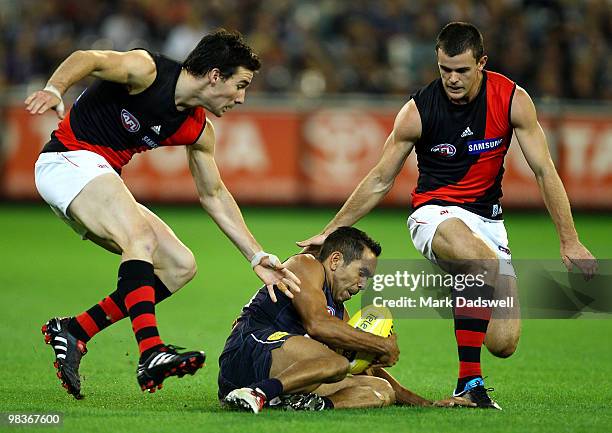 Eddie Betts of the Blues is tackled by Henry Slattery and Brent Stanton of the Bombers during the round three AFL match between the Carlton Blues and...