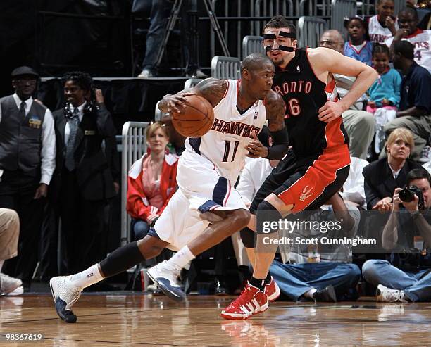 Jamal Crawford of the Atlanta Hawks drives against Hedo Turkoglu of the Toronto Raptors on April 9, 2010 at Philips Arena in Atlanta, Georgia. NOTE...