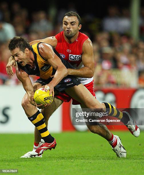 Ben Cousins of the Tigers is tackled by Rhyce Shaw of the Swans during the round three AFL match between the Sydney Swans and the Richmond Tigers at...