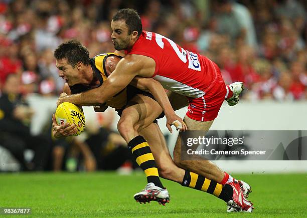 Ben Cousins of the Tigers is tackled by Rhyce Shaw of the Swans during the round three AFL match between the Sydney Swans and the Richmond Tigers at...