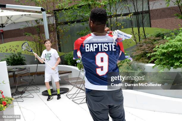 Boston Cannons Trevor Baptiste plays some lacrosse with Eli at Boston Children's Hospital June 25, 2018 in Boston, Massachusetts.