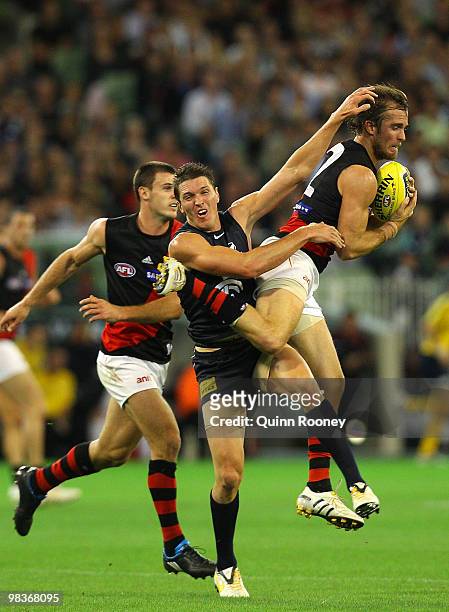 Andrew Welsh of the Bombers marks infront of Ryan Houlihan of the Blues during the round three AFL match between the Carlton Blues and the Essendon...