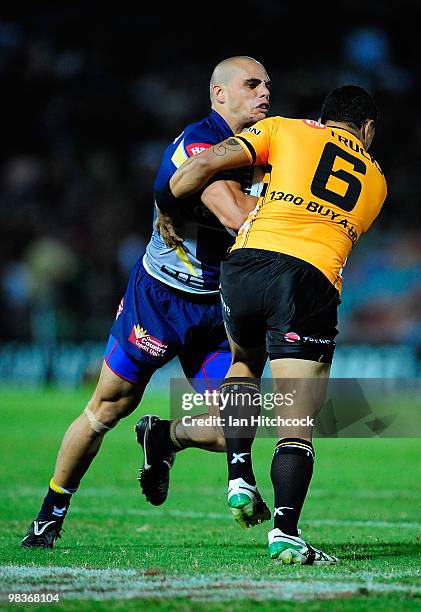 Steve Rapira of the Cowboys is tackled by Benji Marshall of the Tigers during the round five NRL match between the North Queensland Cowboys and the...