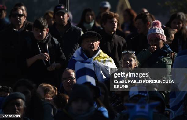 Man wrapped in a Uruguayan national flag watches the World Cup match between Uruguay and Russia at a square in the Russian-founded town of San Javier...