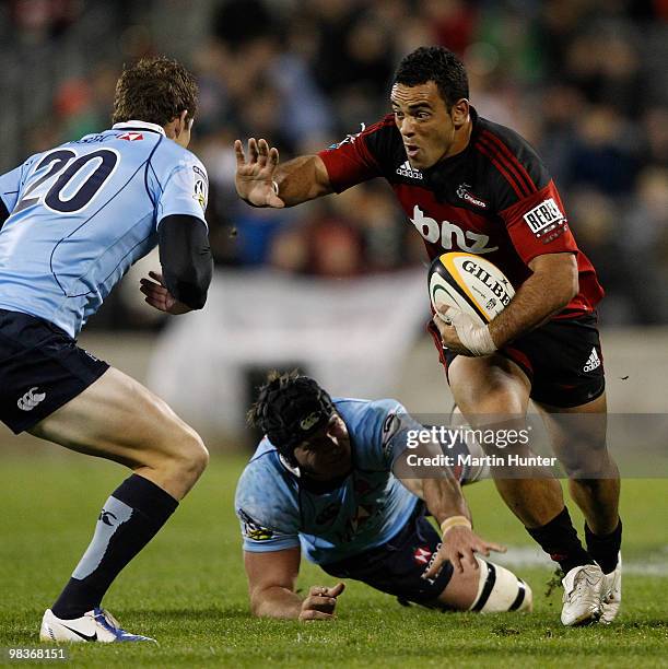 Kahn Fotuali'i of the Crusaders confronts Josh Holmes of the Waratahs as he is tackled during the round nine Super 14 match between the Crusaders and...