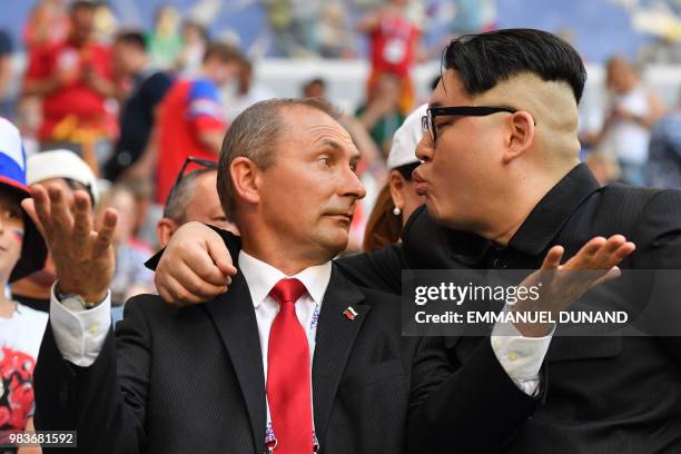 Impersonators of Russian President Vladimir Putin and North Korean leader Kim Jong Un joke during the Russia 2018 World Cup Group A football match...