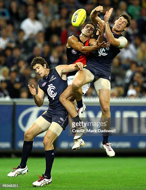 Bachar Houli of the Bombers is caught between Jordan Russell and Michael Jamison of the Blues during the round three AFL match between the Carlton...