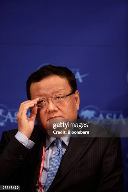 Liu Changle, chairman and chief executive officer of Phoenix Satellite Television, adjusts his glasses during the Boao Forum for Asia in Boao, Hainan...