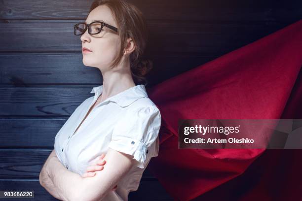 superwoman office worker standing in a suit and red cloak - superwoman stock pictures, royalty-free photos & images