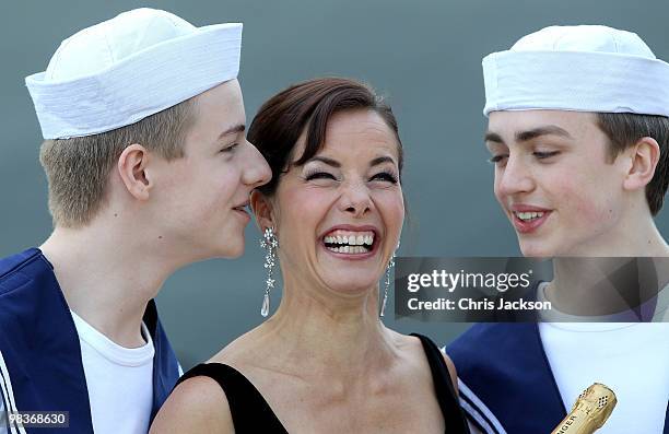 Ballerina Darcey Bussell is kissed by two members of the Royal Ballet School dressed as sailors as she is named as 'Godmother' to P&O's latest Cruise...