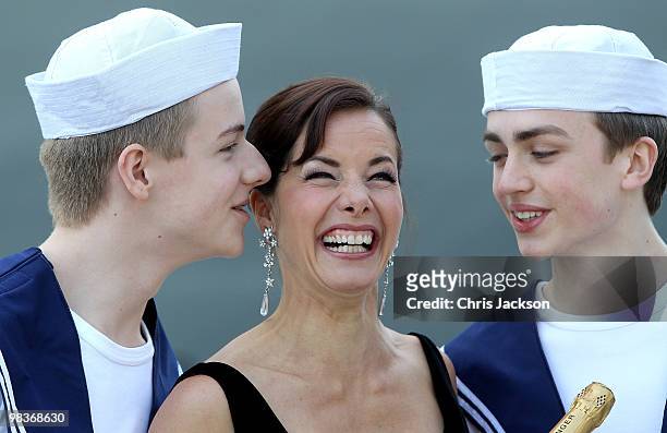 Ballerina Darcey Bussell is kissed by two members of the Royal Ballet School dressed as sailors as she is named as 'Godmother' to P&O's latest Cruise...