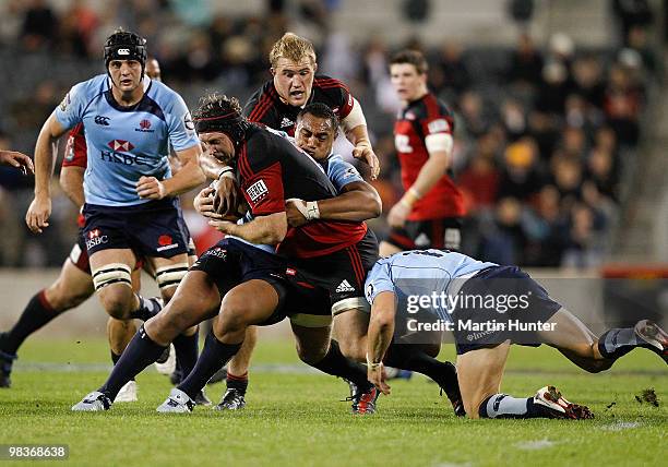 Thomas Waldrom of the Crusaders is tackled as he charges upfield during the round nine Super 14 match between the Crusaders and the Waratahs AMI...