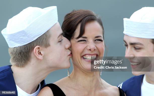 Ballerina Darcey Bussell is kissed by two members of the Royal Ballet School dressed as sailors as she is named as 'Godmother' to P&O's latest Cruise...