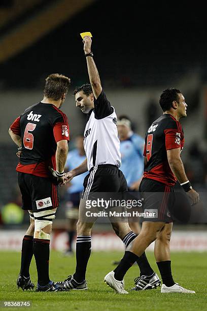 Referee Graig Joubeert yellow cards Kahn Fotuali'i of the Crusaders as Richie McCaw looks on during the round nine Super 14 match between the...