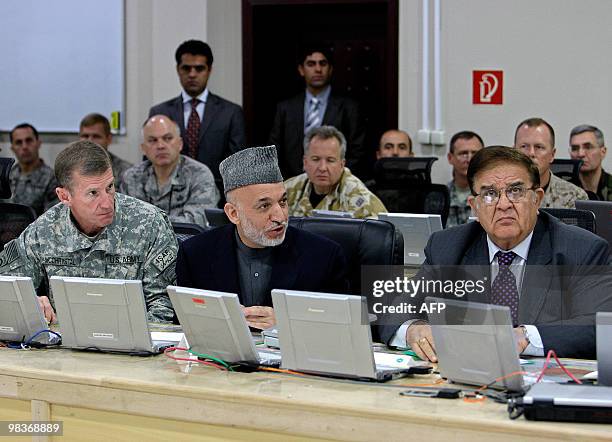 Afghan President Karzai speaks as Commander of US and NATO troops, General Stanley McChrystal and Afghan Defence Minister Abdul Rahim Wardak look on...