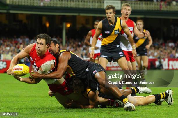 Shane Mumford of the Swans hand-passes the ball during the round three AFL match between the Sydney Swans and the Richmond Tigers at Sydney Cricket...