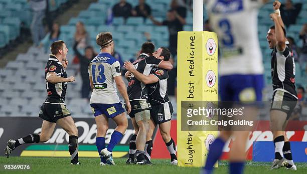 Warriors players celebrate after the winning try by Lance Hohaia during the round five NRL match between the Canterbury Bulldogs and the Warriors at...