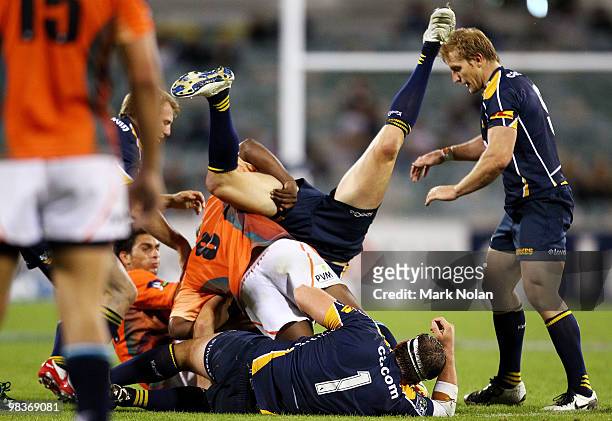 Julian Huxley of the Brumbies is dumped by Kabamba Floors of the Cheetahs during the round nine Super 14 match between the Brumbies and the Cheetahs...