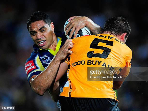 Willie Tonga of the Cowboys is tackled by Mitch Brown of the Tigers during the round five NRL match between the North Queensland Cowboys and the West...
