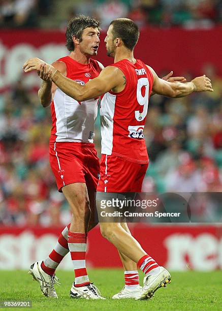 Brett Kirk of the Swans congratulates team mate Nick Malceski after kicking a goal during the round three AFL match between the Sydney Swans and the...