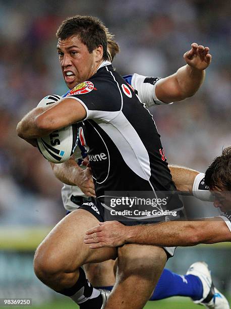 Joel Moon of the Warriors is tackled during the round five NRL match between the Canterbury Bulldogs and the Warriors at ANZ Stadium on April 10,...